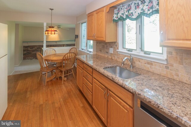 104 Dorado Dr, Delran, NJ 08075 - kitchen featuring light stone countertops, a sink, light wood-style floors, dishwasher, and tasteful backsplash