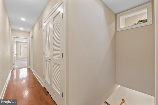 hall featuring recessed lighting, baseboards, visible vents, and hardwood / wood-style floors