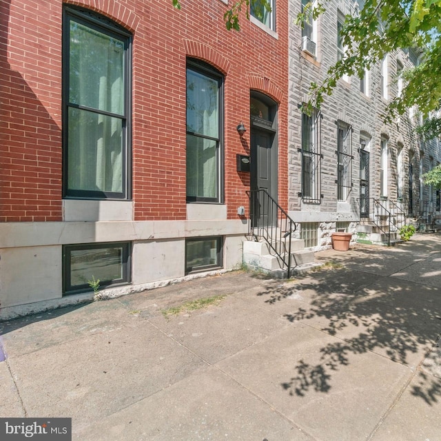 exterior space with brick siding and cooling unit