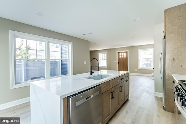 204 Barclay St, Burlington, NJ 08016 - kitchen with stainless steel appliances, baseboards, a sink, and light wood-style flooring
