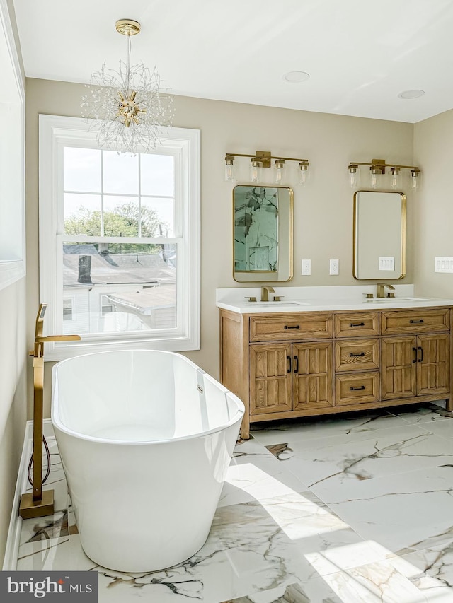 204 Barclay St, Burlington, NJ 08016 - full bathroom featuring double vanity, a freestanding tub, a notable chandelier, a sink, and marble finish floor