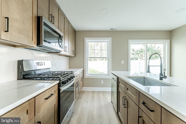204 Barclay St, Burlington, NJ 08016 - kitchen with visible vents, appliances with stainless steel finishes, a sink, baseboards, and light wood-style flooring