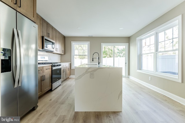 204 Barclay St, Burlington, NJ 08016 - kitchen with a sink, baseboards, stainless steel appliances, and light wood finished floors