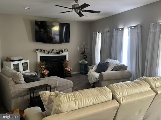 carpeted living room featuring a ceiling fan, a fireplace with flush hearth, and recessed lighting
