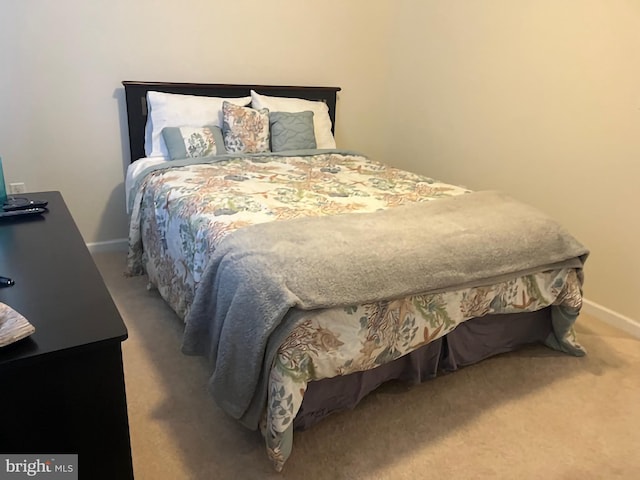bedroom featuring baseboards and carpet floors