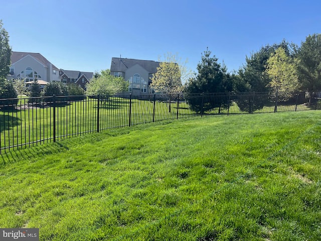 view of yard featuring fence and a residential view