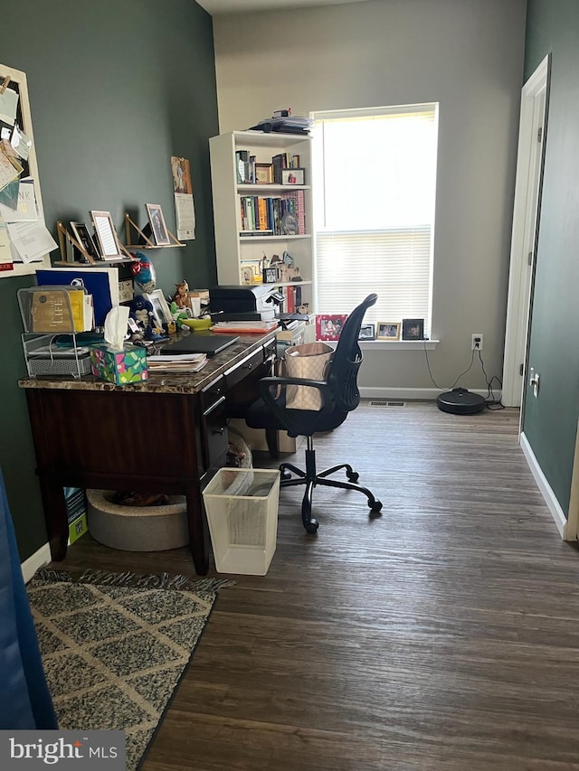 office area with baseboards, wood finished floors, and visible vents