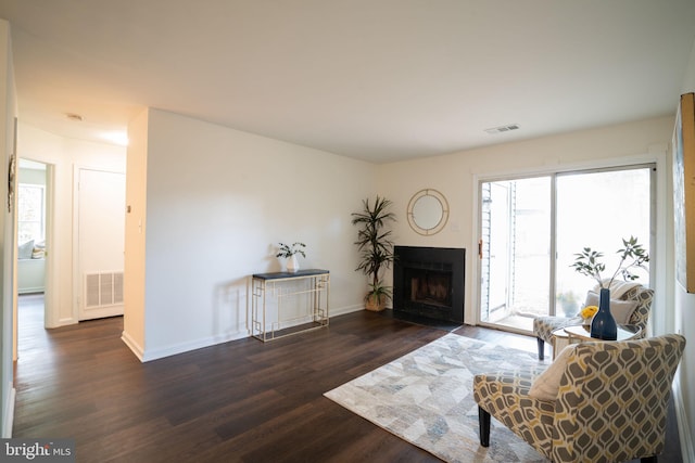 8607 Beekman Pl Unit 7B, Alexandria, VA 22309 - living area with wood finished floors, baseboards, and a fireplace