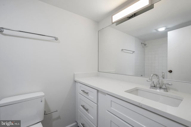 full bath with vanity, toilet, baseboards, and a shower