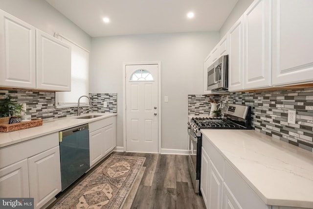 kitchen with white cabinets, appliances with stainless steel finishes, and a sink