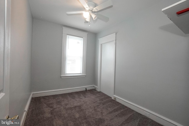 spare room featuring carpet floors, a ceiling fan, and baseboards