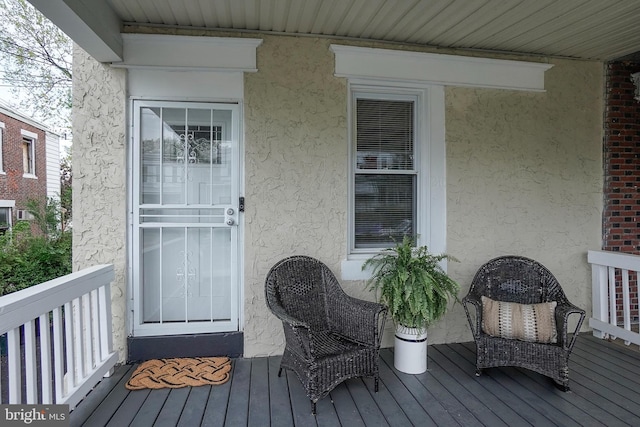 view of exterior entry with stucco siding