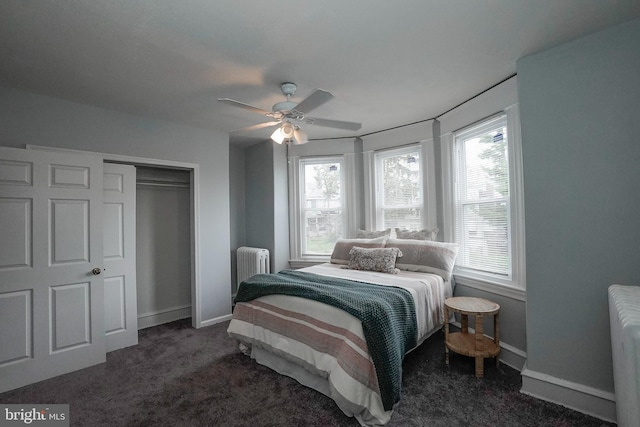 carpeted bedroom with baseboards, ceiling fan, radiator heating unit, and a closet