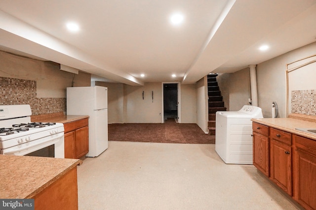 kitchen featuring washer / dryer, light countertops, brown cabinetry, and white appliances