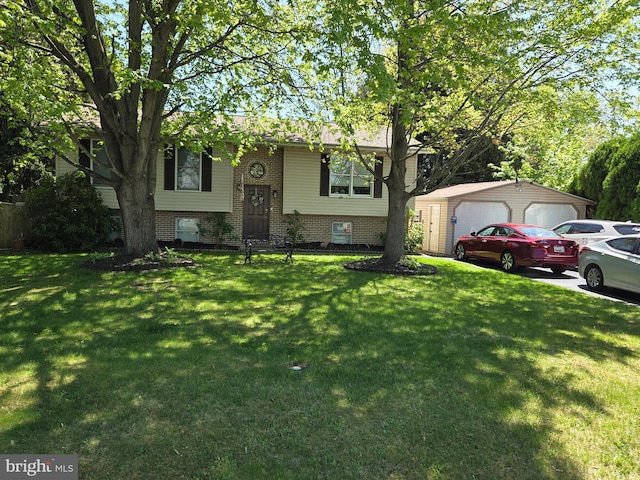 raised ranch with brick siding, a front lawn, an outbuilding, and a detached garage
