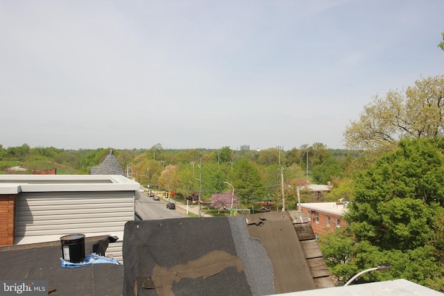 exterior details featuring a wooded view