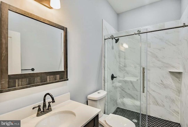 bathroom featuring vanity, a stall shower, and toilet