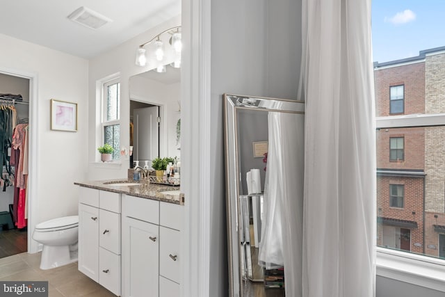 6101 Enquirer St, Hyattsville, MD 20782 - bathroom featuring toilet, vanity, a walk in closet, and plenty of natural light