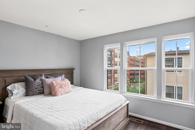 6101 Enquirer St, Hyattsville, MD 20782 - bedroom featuring dark wood-type flooring, multiple windows, and baseboards