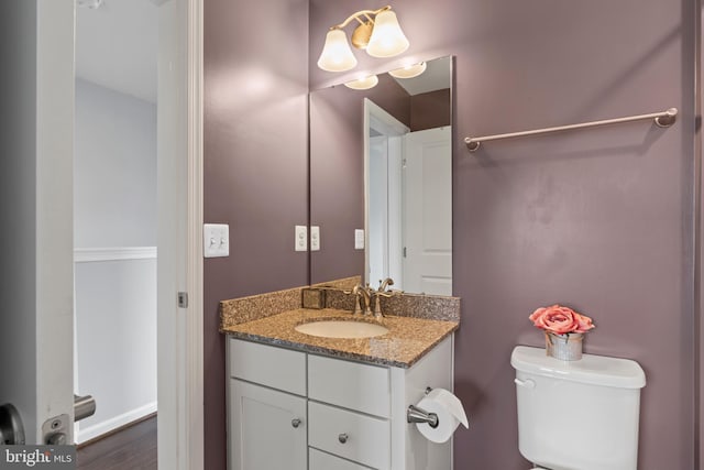 6101 Enquirer St, Hyattsville, MD 20782 - half bathroom featuring vanity, toilet, and wood finished floors