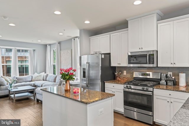 6101 Enquirer St, Hyattsville, MD 20782 - kitchen with appliances with stainless steel finishes, open floor plan, white cabinetry, a center island, and recessed lighting