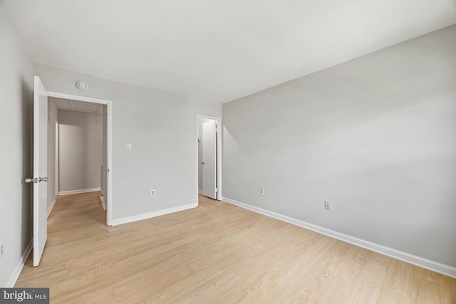 565 W Diamond Ave Unit 27, Gaithersburg, MD 20877 - unfurnished bedroom featuring attic access, light wood-type flooring, and baseboards