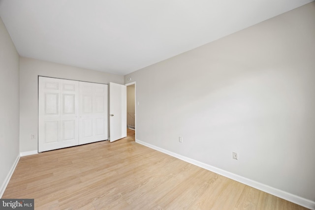 565 W Diamond Ave Unit 27, Gaithersburg, MD 20877 - unfurnished bedroom with baseboards, light wood-style flooring, and a closet