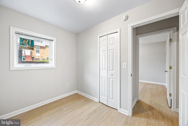 565 W Diamond Ave Unit 27, Gaithersburg, MD 20877 - unfurnished bedroom with light wood finished floors, baseboards, and a closet