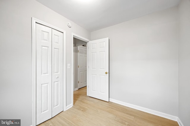 565 W Diamond Ave Unit 27, Gaithersburg, MD 20877 - unfurnished bedroom with light wood-type flooring, baseboards, and a closet