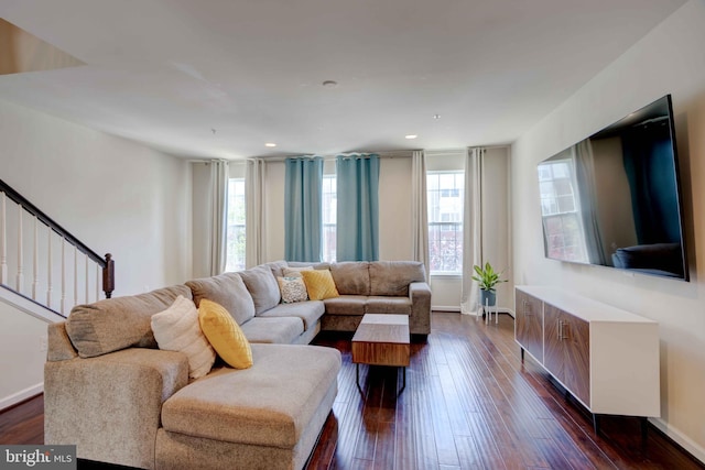 living room with dark wood-style flooring, baseboards, stairway, and recessed lighting