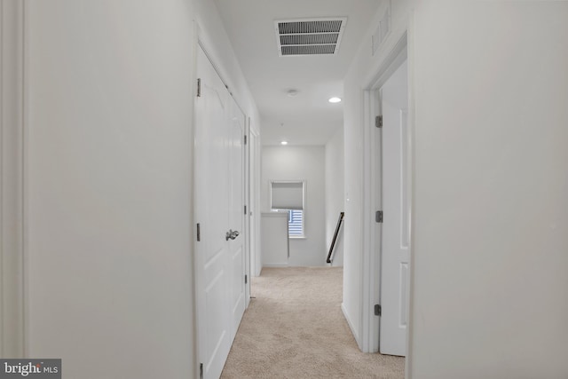 corridor with recessed lighting, visible vents, light carpet, and an upstairs landing
