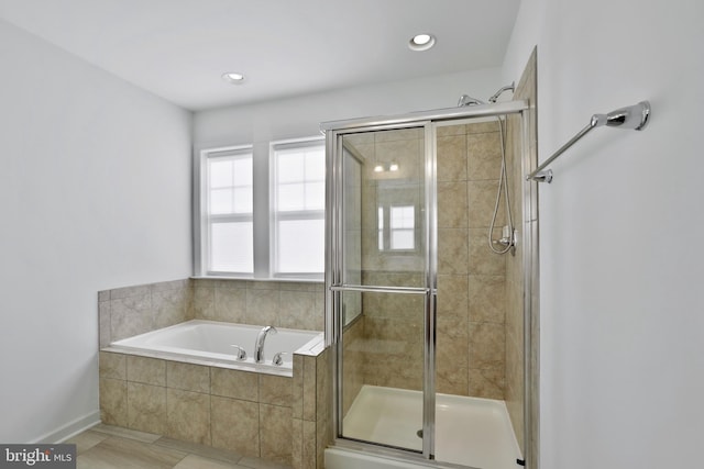 bathroom featuring a shower stall, recessed lighting, and a bath