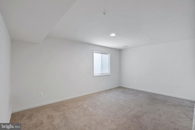 empty room with carpet floors, recessed lighting, and baseboards