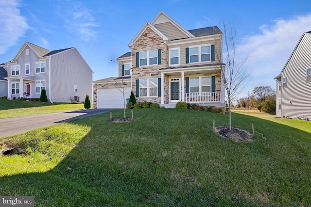 view of front of property with a porch, a front yard, driveway, and stone siding