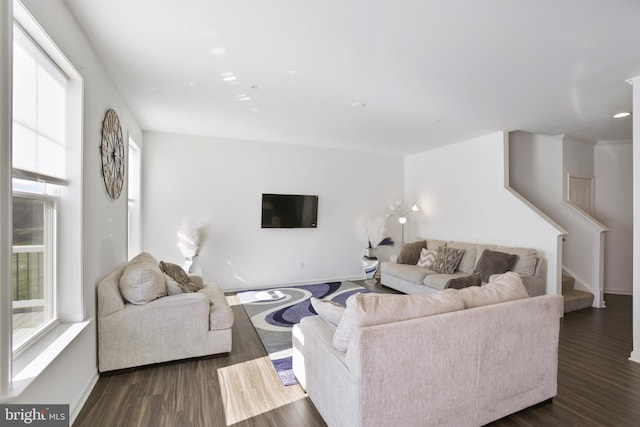living room featuring stairway, baseboards, and dark wood-style flooring