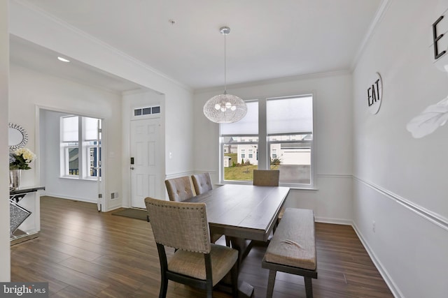 dining space with baseboards, ornamental molding, dark wood-style floors, and a notable chandelier