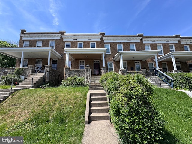 4702 Kernwood Ave, Baltimore, MD 21212 - multi unit property with stairs, a porch, brick siding, and a front lawn