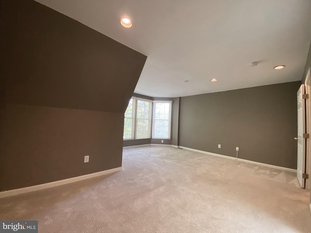 additional living space featuring baseboards, light carpet, and recessed lighting