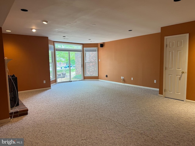 unfurnished living room with baseboards, carpet flooring, and recessed lighting