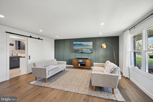 48 Evergreen Ln, Burlington, NJ 08016 - living room with a decorative wall, wood finished floors, baseboards, recessed lighting, and a barn door