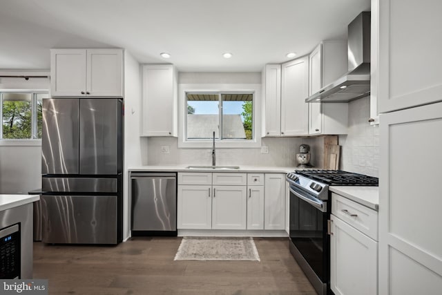 48 Evergreen Ln, Burlington, NJ 08016 - kitchen featuring white cabinets, appliances with stainless steel finishes, a sink, and wall chimney exhaust hood