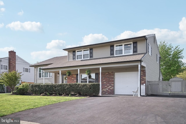 48 Evergreen Ln, Burlington, NJ 08016 - traditional home with roof with shingles, an attached garage, a front lawn, brick siding, and driveway