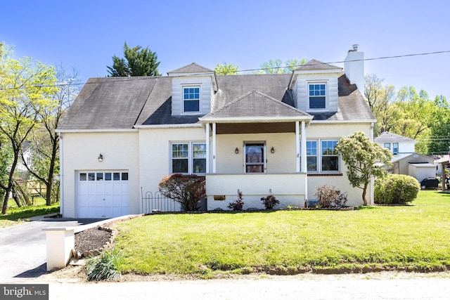 cape cod-style house with a garage, stucco siding, driveway, and a front lawn