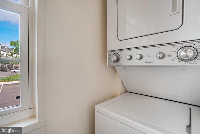 clothes washing area featuring laundry area and stacked washer / dryer