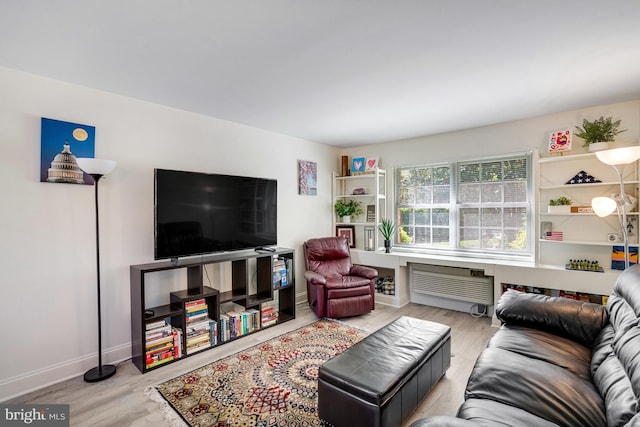 living area with baseboards and wood finished floors