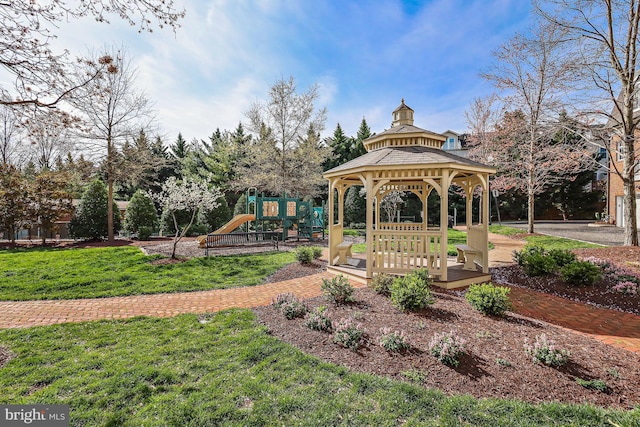 view of property's community featuring a lawn, a gazebo, and playground community