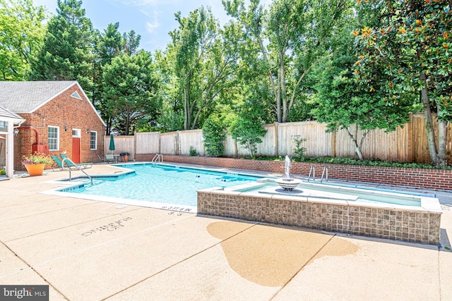 pool with a fenced backyard and a patio area