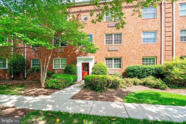 view of property with brick siding