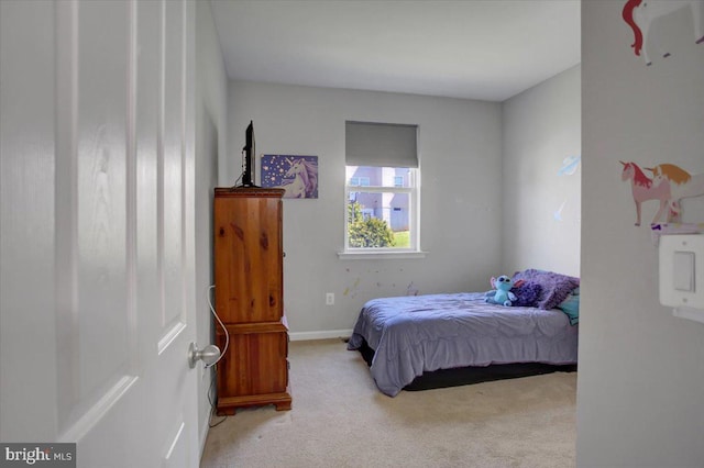 bedroom with carpet floors and baseboards