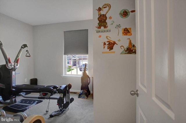 workout room featuring carpet floors and baseboards